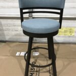 Blue cushioned bar stool with black frame and footrest.