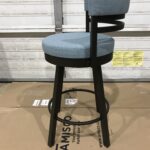 Blue cushioned bar stool with black metal frame and footrest.
