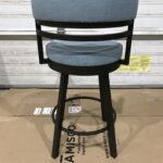 A swivel bar stool with a blue cushioned seat and backrest.