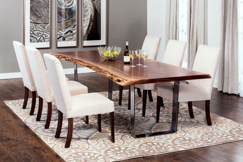 Elegant dining room with a live-edge wooden table and white upholstered chairs.