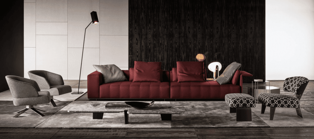 Elegant modern living room with a deep red sofa and minimalist decor.